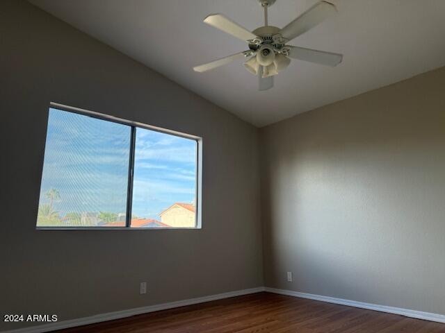 unfurnished room with ceiling fan and dark hardwood / wood-style flooring