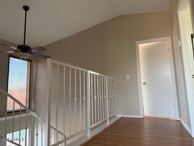 hallway featuring lofted ceiling and hardwood / wood-style floors