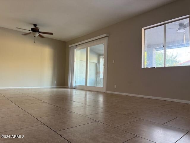 empty room featuring ceiling fan and light tile patterned floors