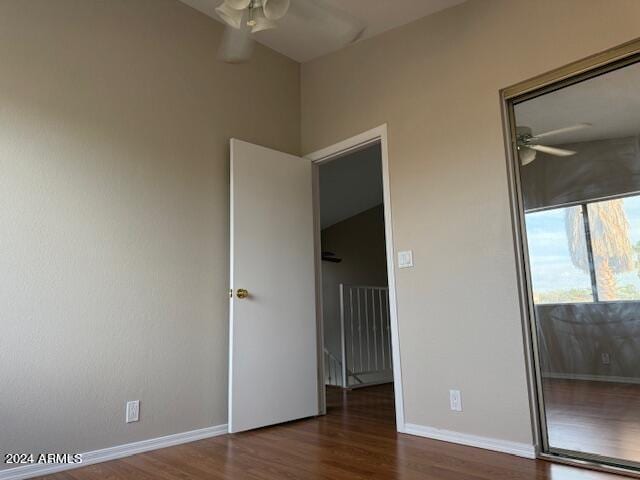 unfurnished bedroom featuring ceiling fan and dark hardwood / wood-style flooring