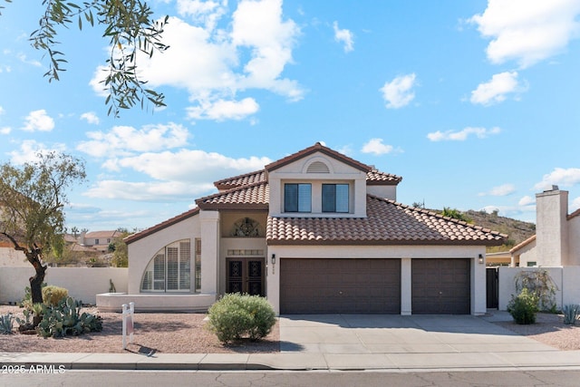 mediterranean / spanish-style home with a garage