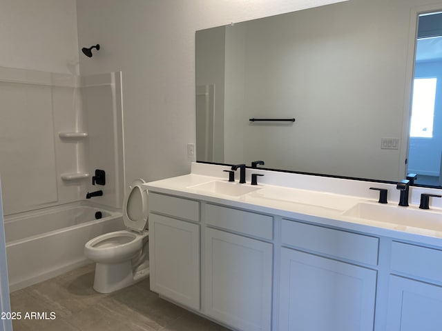 full bathroom with double vanity, toilet, shower / bath combination, and a sink