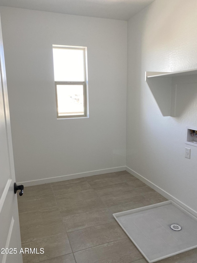 unfurnished room with baseboards