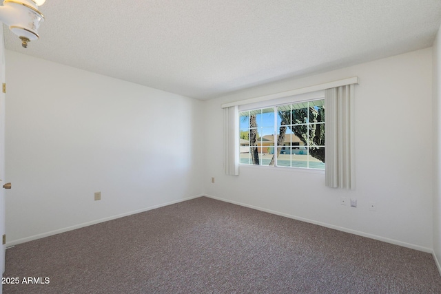 carpeted spare room with a textured ceiling