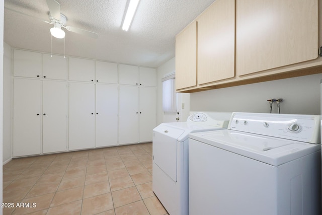 clothes washing area featuring washer and dryer, cabinets, light tile patterned floors, ceiling fan, and a textured ceiling