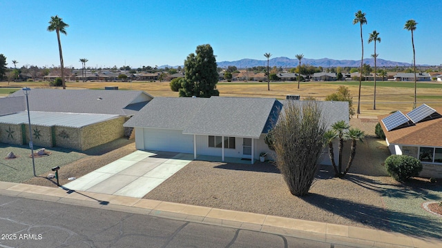 single story home with a garage and a mountain view