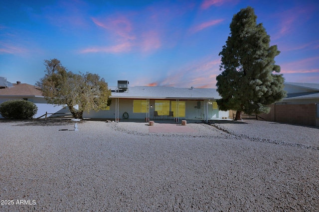 view of front facade with central AC and a patio area