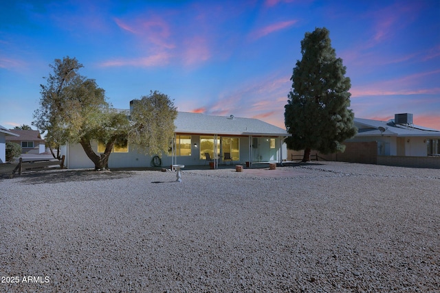 view of front of house with a patio area and central air condition unit