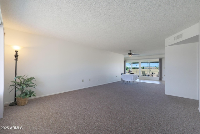 unfurnished room with ceiling fan, carpet floors, and a textured ceiling