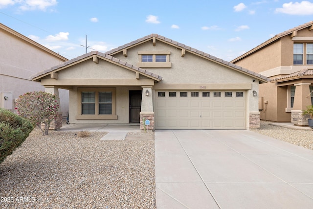 view of front of property featuring stucco siding, concrete driveway, an attached garage, and a tiled roof