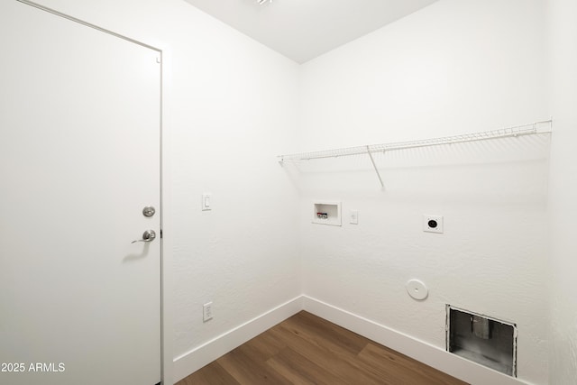 laundry room with dark wood-type flooring, washer hookup, baseboards, gas dryer hookup, and laundry area