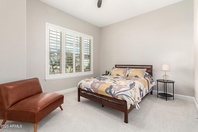 bedroom with baseboards, light colored carpet, and a ceiling fan