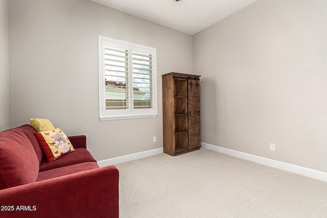 sitting room with carpet and baseboards