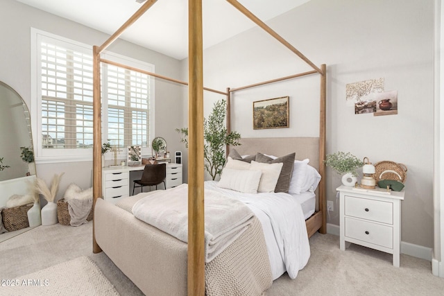 bedroom featuring baseboards and light carpet