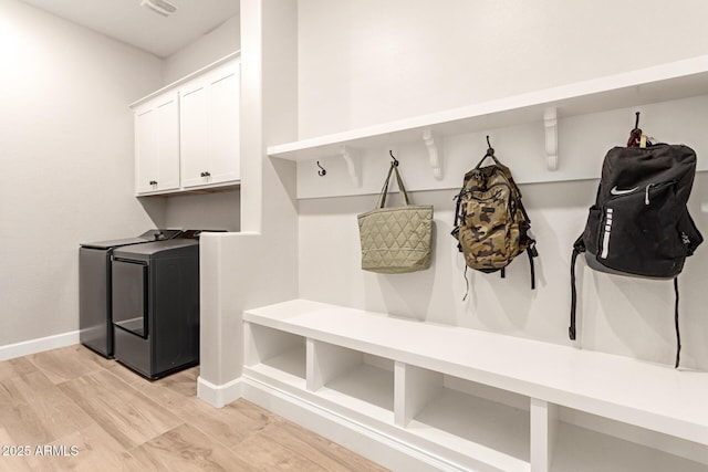 mudroom with baseboards, independent washer and dryer, and light wood-style flooring