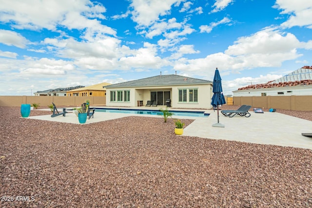 back of house featuring a patio, a fenced backyard, and a fenced in pool