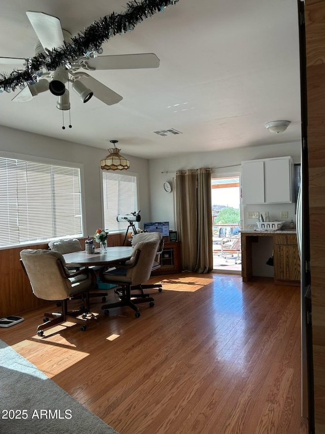 dining space featuring ceiling fan and hardwood / wood-style floors