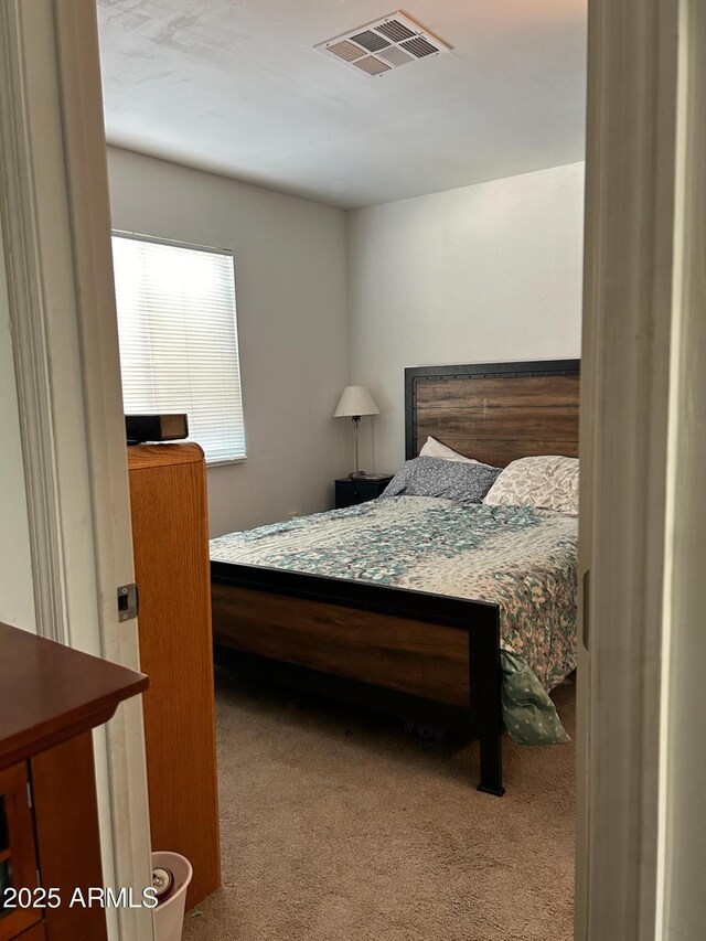 bedroom with light colored carpet