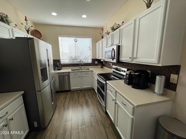 kitchen featuring stainless steel appliances, white cabinets, decorative backsplash, sink, and dark hardwood / wood-style floors