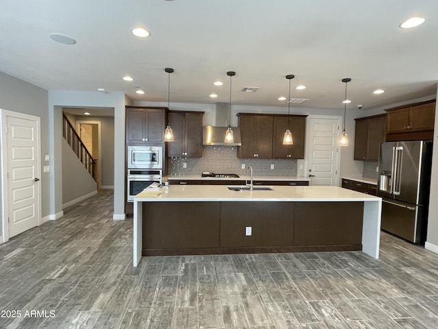 1840 S Follett Way, Gilbert, AZ 85295 - kitchen featuring stainless steel appliances, a sink, a large island with sink, wood finished floors, and dark brown cabinetry