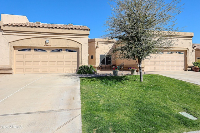 mediterranean / spanish house with concrete driveway, an attached garage, and stucco siding