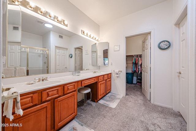 full bath with double vanity, a shower stall, visible vents, and a sink