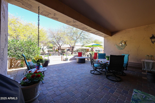 view of patio featuring outdoor dining area and fence