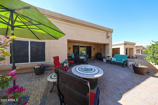 view of patio / terrace with an outdoor living space with a fire pit