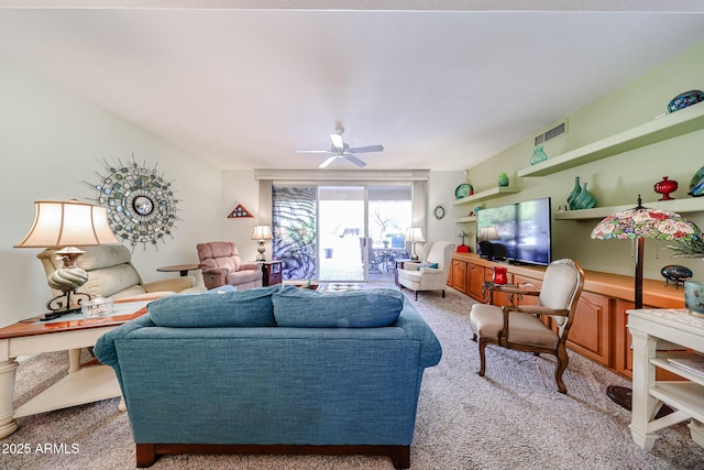 carpeted living area with ceiling fan and visible vents