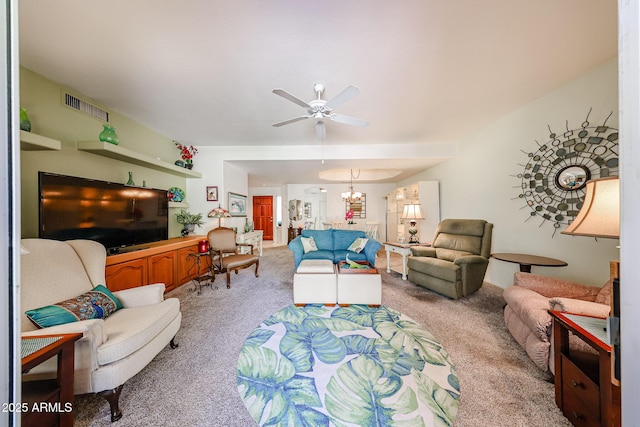 living area featuring light carpet, ceiling fan with notable chandelier, and visible vents