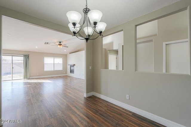 spare room with dark hardwood / wood-style flooring and ceiling fan with notable chandelier