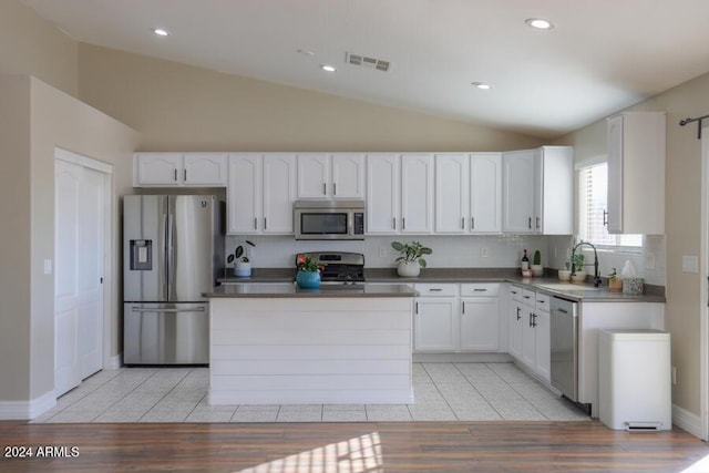 kitchen with white cabinetry, sink, backsplash, light tile patterned floors, and appliances with stainless steel finishes