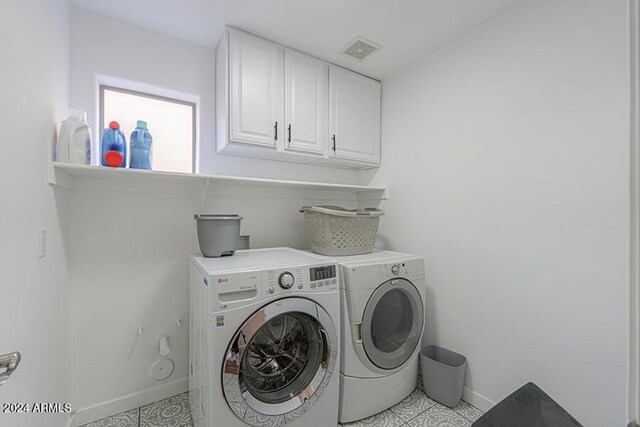 laundry area with cabinets and washer and dryer