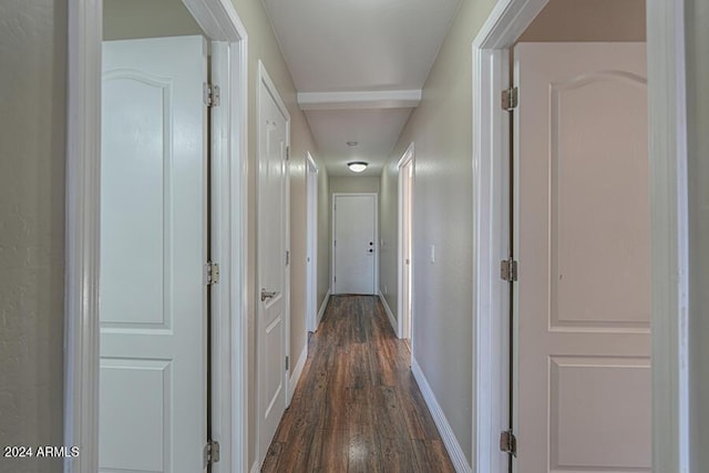 corridor with dark wood-type flooring