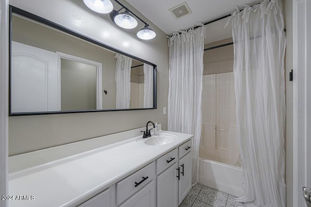 bathroom with tile patterned floors, shower / bath combo with shower curtain, and vanity