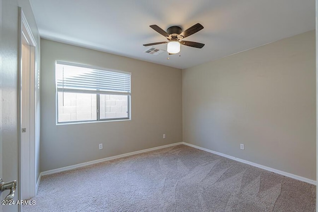 unfurnished room featuring light colored carpet and ceiling fan