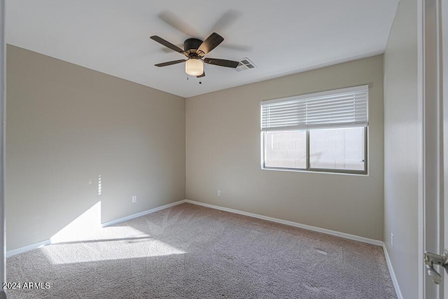 spare room featuring carpet and ceiling fan