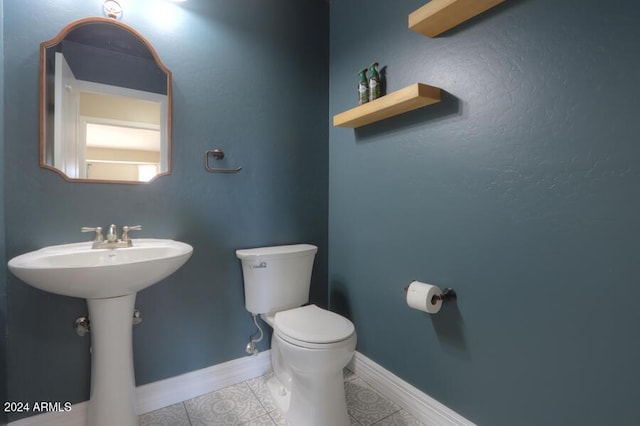 bathroom featuring tile patterned flooring and toilet