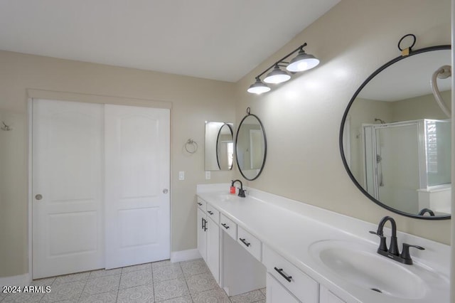 bathroom featuring tile patterned flooring, vanity, and a shower with door