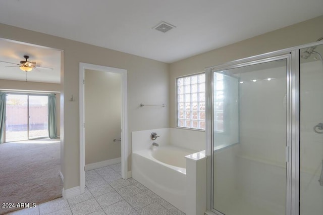 bathroom featuring plus walk in shower, plenty of natural light, and ceiling fan