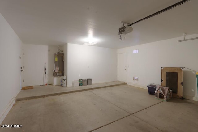 garage featuring strapped water heater and a garage door opener