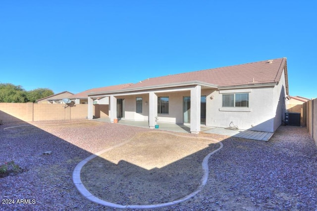 rear view of property featuring central AC unit and a patio