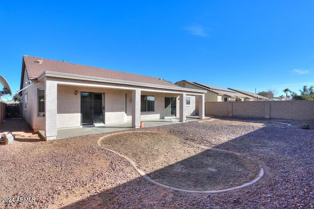 back of house with a patio