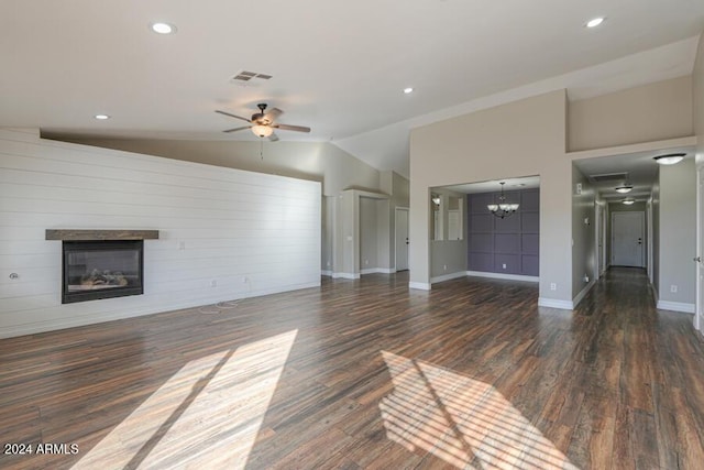 unfurnished living room with ceiling fan with notable chandelier, dark hardwood / wood-style flooring, and lofted ceiling