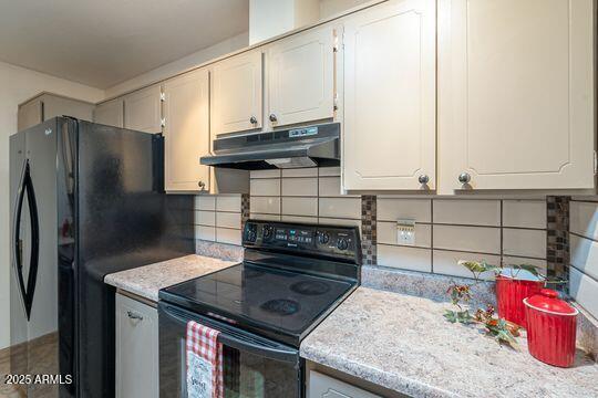 kitchen with black appliances, under cabinet range hood, white cabinetry, and light countertops