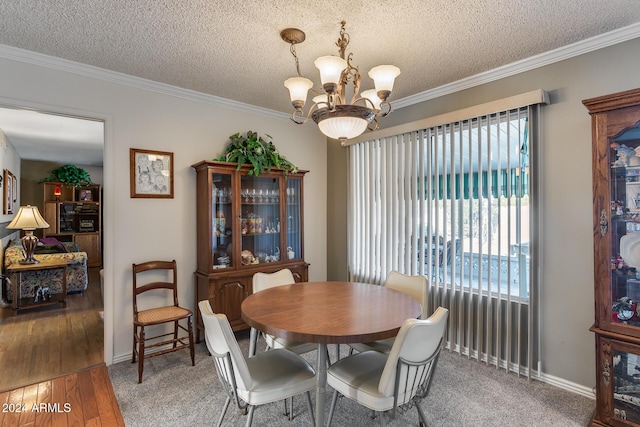 dining area with wood-type flooring, crown molding, and a notable chandelier