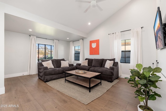 living room featuring recessed lighting, ceiling fan, wood finished floors, high vaulted ceiling, and baseboards