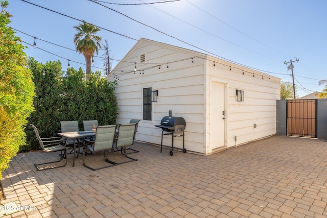 exterior space with a gate and outdoor dining area