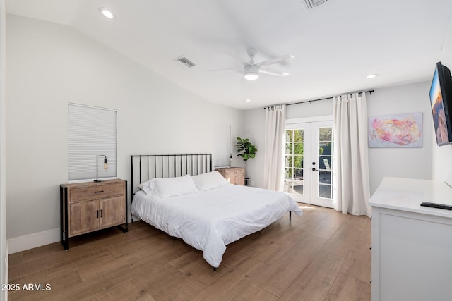 bedroom featuring french doors, light wood finished floors, visible vents, vaulted ceiling, and access to outside