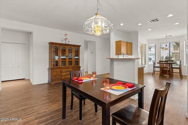8237 W Alex Ave, Peoria, AZ 85382 - dining area with visible vents, dark wood-style flooring, baseboards, and a notable chandelier